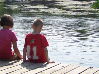 Children sitting on dock
